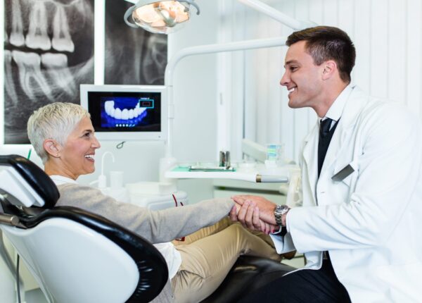 Beautiful senior woman having dental treatment at dentist's office.